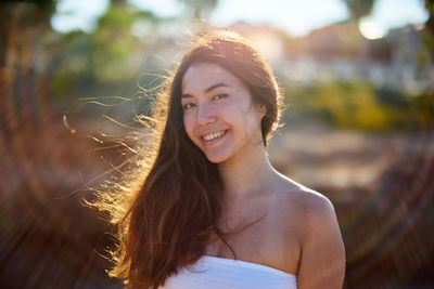 Portrait of young woman during sunny day