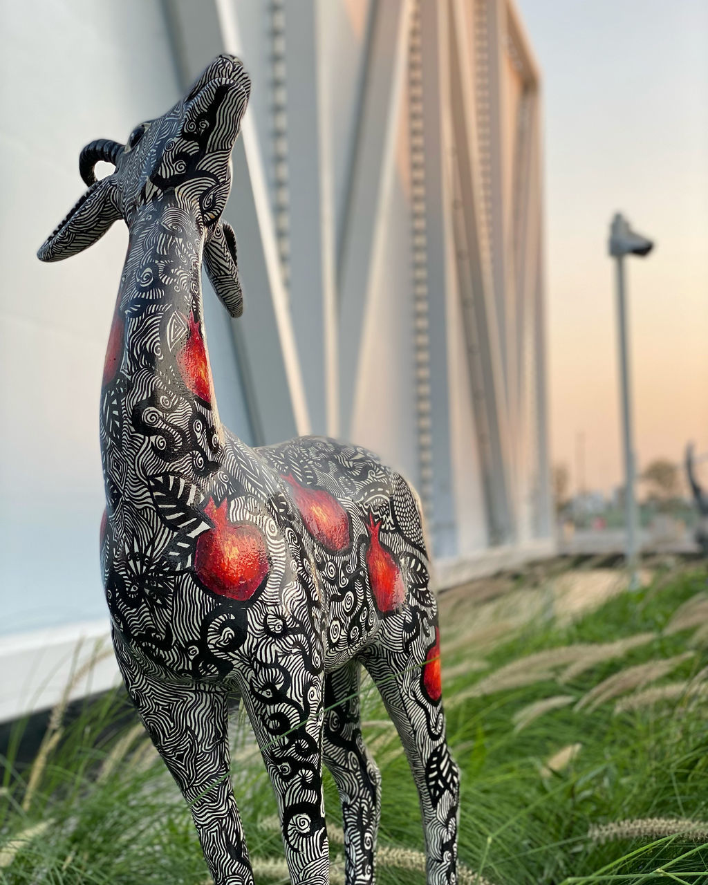 animal, statue, animal representation, architecture, animal themes, sculpture, nature, no people, representation, art, built structure, grass, focus on foreground, day, outdoors, plant, sky, craft, mammal, travel destinations, building exterior, city, animal wildlife, creativity, bird