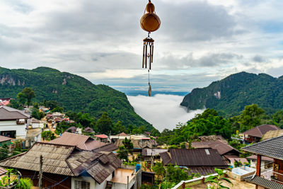 Houses by town against sky