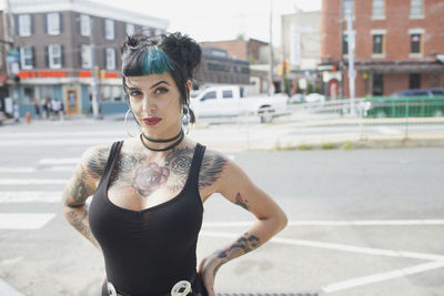 A portrait of a young woman with black and blue hair.