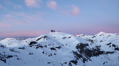 Scenic view of snow covered mountains against sky during sunset