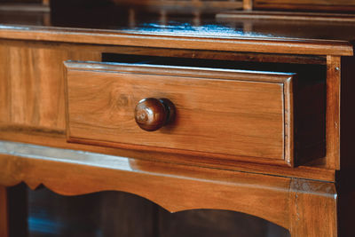 Close-up of cup on wood at home