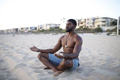 Young man sitting on beach