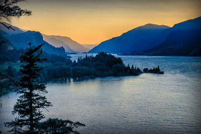 Scenic view of snowcapped mountains against sky during sunset