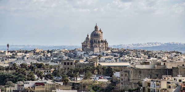 High angle view of buildings in city against sky