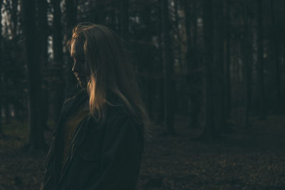 Side view of woman in forest