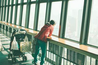 Man walking by railing in building