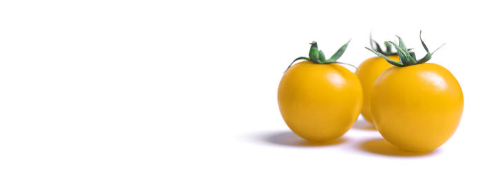 Close-up of yellow bell peppers on white background