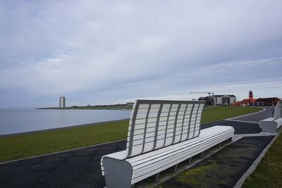 Footpath by sea against sky