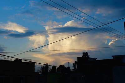 Low angle view of power lines against sky