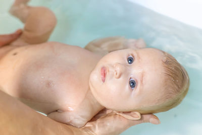 Close-up of cute baby girl taking bath