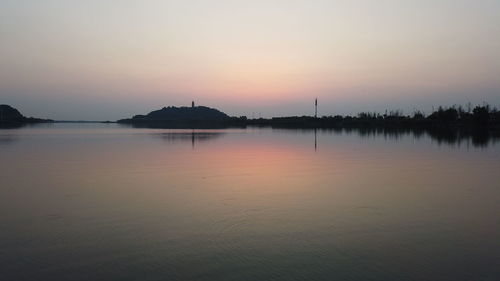 Scenic view of lake against sky during sunset