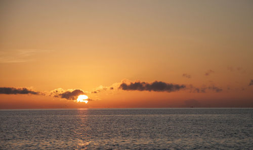 Scenic view of sea against romantic sky at sunset