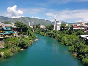 River amidst buildings against sky