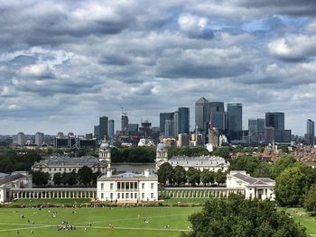 View of cityscape against cloudy sky