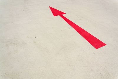 High angle view of arrow sign on road