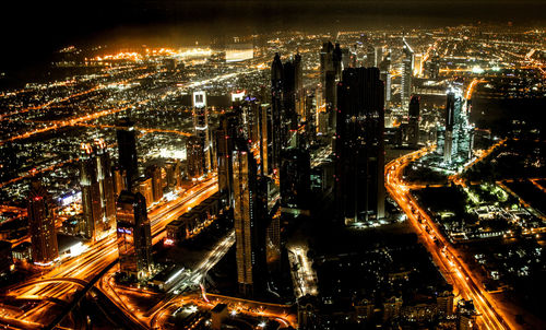 High angle view of city lit up at night