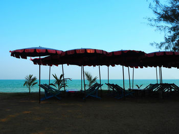 Scenic view of beach against clear blue sky