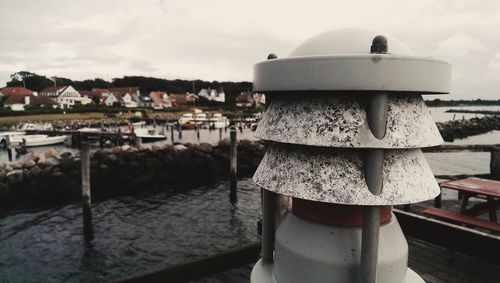 Close-up of built structure by sea against sky