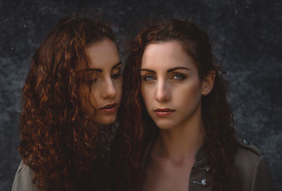 Portrait of siblings against wall