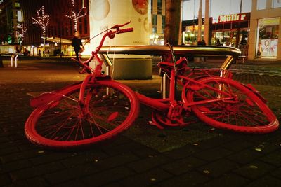 Bicycle parked on street at night