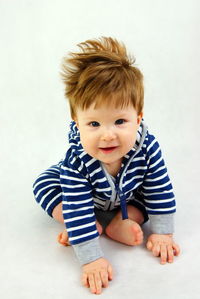 Portrait of cute boy against white background