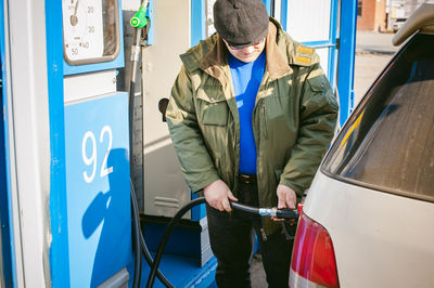 Man filling fuel in car