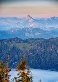 Scenic view of snowcapped mountains against sky at sunset