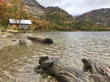 Scenic view of lake by mountain against sky