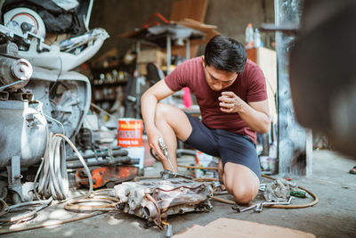 Side view of man working at market stall