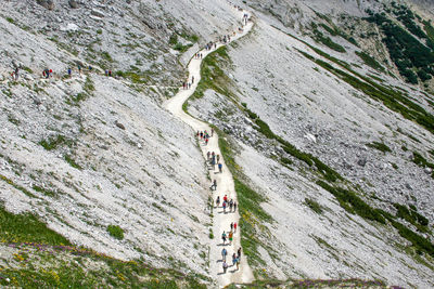 High angle view of people on rock against mountain