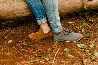 Low section of woman wearing shoes on ground