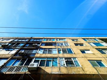 Low angle view of building against clear blue sky