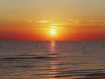 Scenic view of sea against orange sky