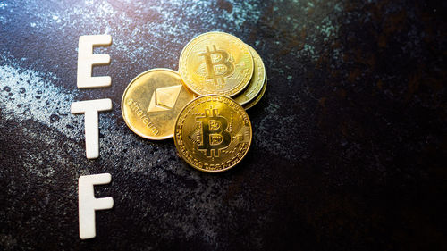 Close-up of bitcoin with text on table