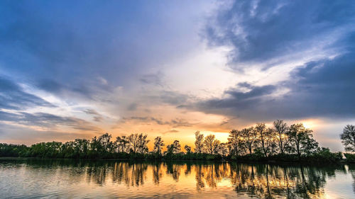 Scenic view of river against sky during sunset