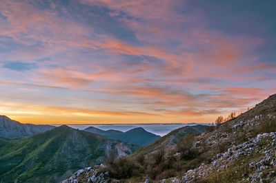 Scenic view of mountains against sky during sunset