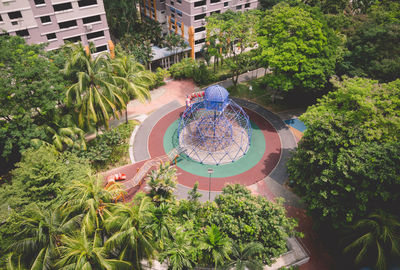 High angle view of trees and buildings in city