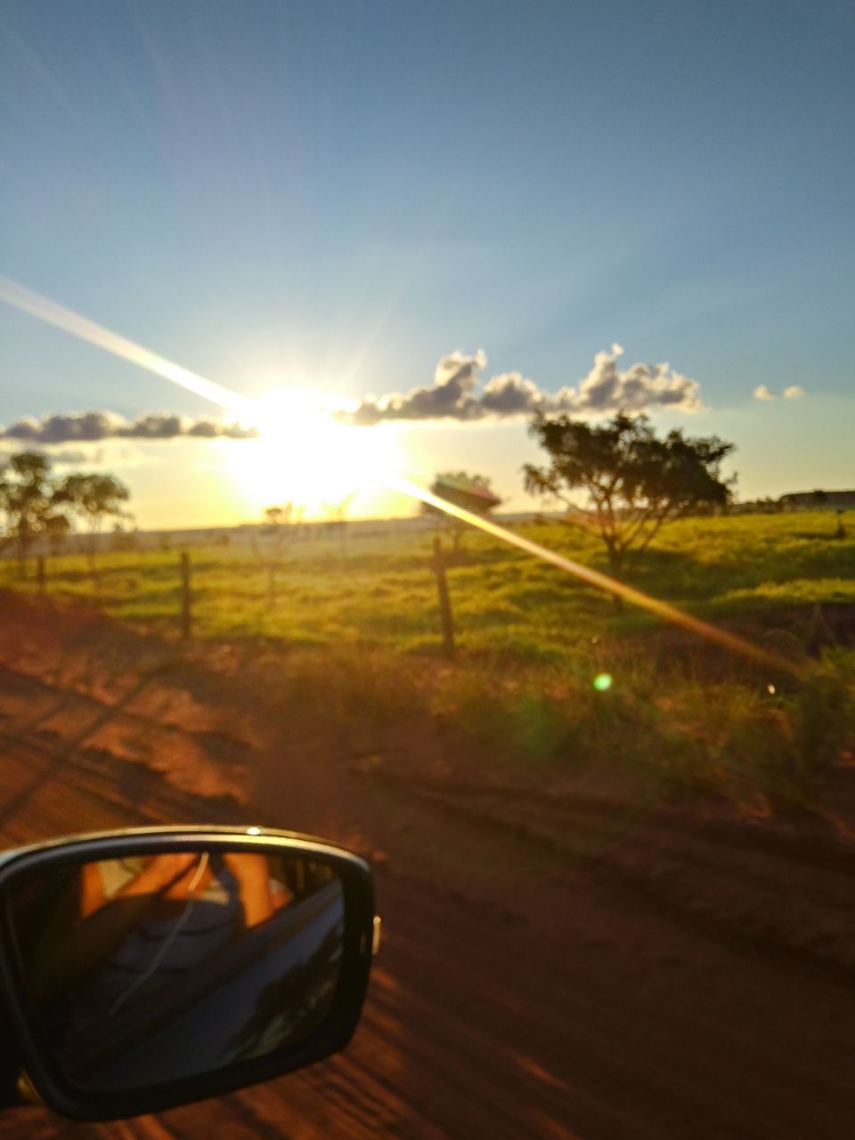 CAR ON FIELD AGAINST BRIGHT SUN