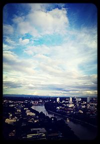 Cityscape against cloudy sky