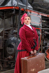 Portrait of woman standing in factory