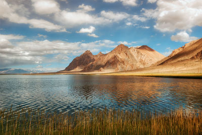 Scenic view of lake and mountains against sky