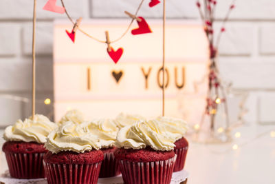 Close-up of cupcakes with decorations on table