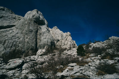 Low angle view of rock formation against sky