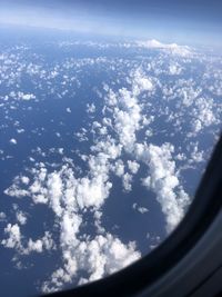 Aerial view of cloudscape seen from airplane window