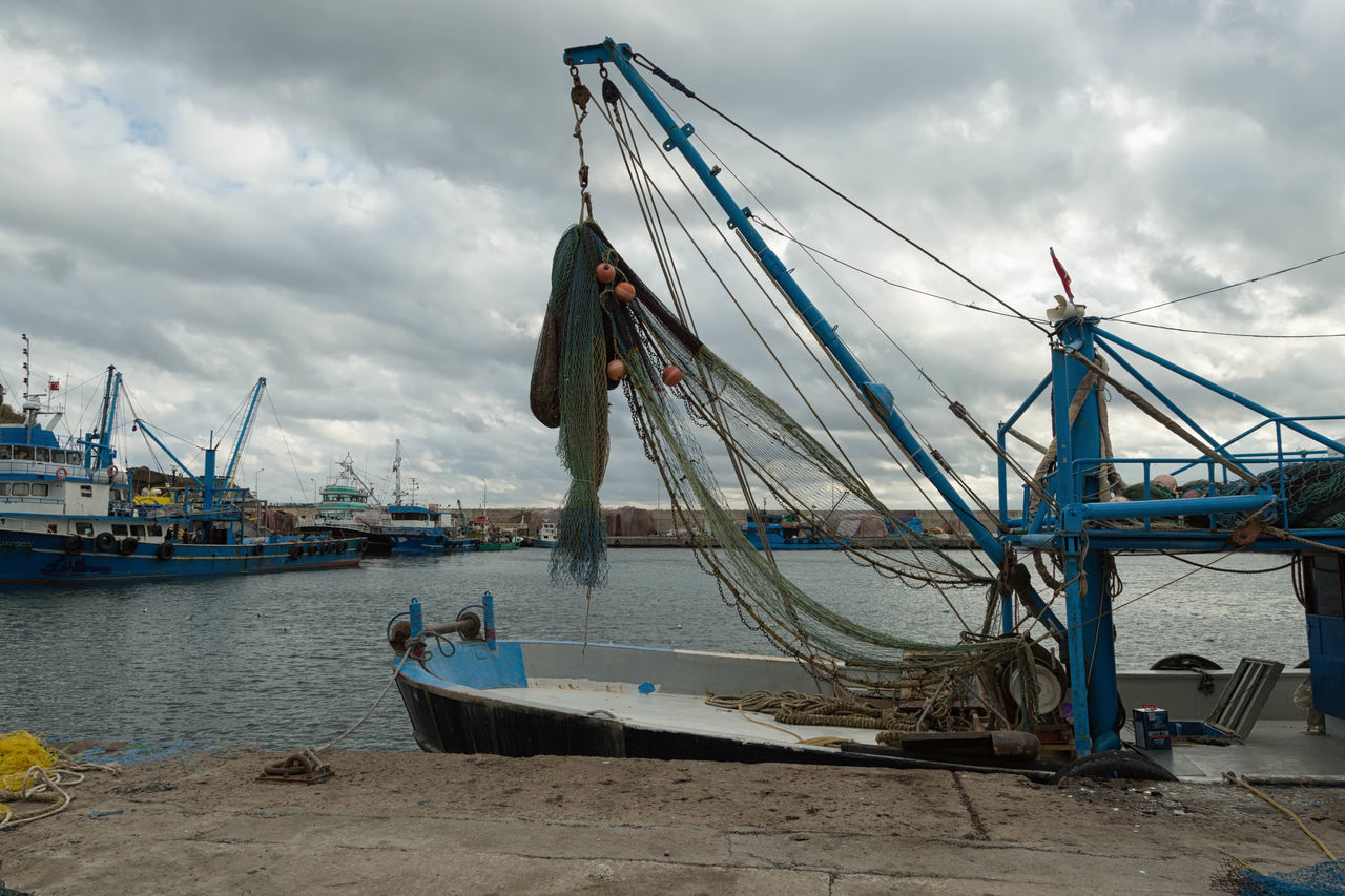 A wooden boat: vessel, craft, watercraft, ship; boat, fishing boat, sail,