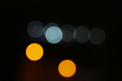 Defocused lights against sky at night