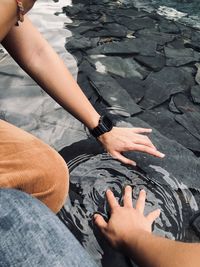 High angle view of people touching water