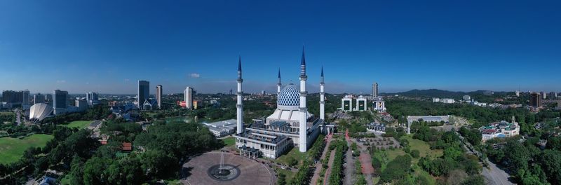 Panoramic view of buildings against blue sky
