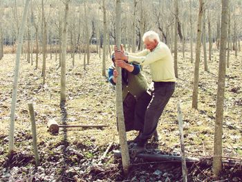 Full length of senior couple pulling trees